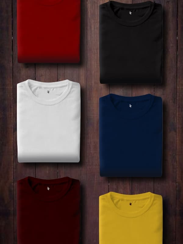 Six folded plain cotton t-shirts in assorted colours
