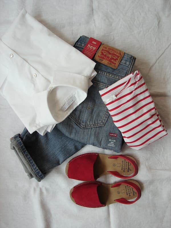 A folded white shirt, straight-leg jeans and a striped top