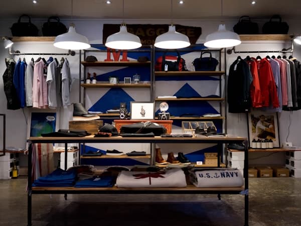 Neatly merchandised shirts and menswear on studio shelving